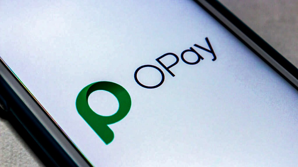 OPay mobile payments app on a smartphone beside the New York Stock Exchange building as the Nigerian fintech files for its IPO